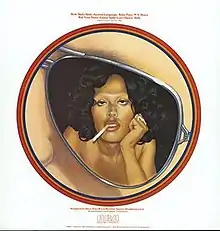 An album cover features a white background and red text, too low resolution to read. The central image in a red circular frame is a close-up of an aviator sunglass lens showing a woman posed, sultry, leaning her head on her hand with a cigarette hanging from her mouth. A cloud of dark hair surrounds her and her shoulders are bare.