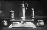 Black and white photograph of six pieces of copper and pewter work