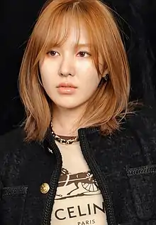 Wendy with brown hair wearing Celine shirt