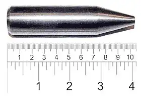 Shiny metallic cylinder with a sharpened tip. The overall length is 9 cm and diameter about 2 cm.