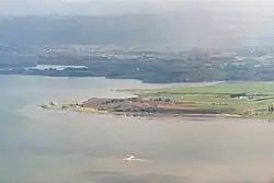 Aerial view of northern Karaka, with Papakura and the Hunua Ranges in the background.