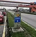 An old-style kilometre marker stone at the SkyPark Terminal with 9 kilometres towards Sungai Buloh.