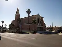 Blessed Sacrament Catholic Church: College Area Business District signs hang from the streetlight in front.