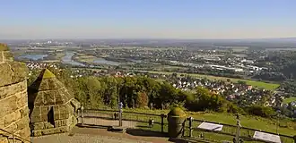 Looking northeast towards Barkhausen (foreground), the River Weser, the Green Bridge (old railway bridge), the B 65 bridge (behind) and the village of Neesen on the other side of the river Weser
