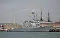 USS Mitscher at Portsmouth in October 2008 with the masts of HMS&nbsp;Victory in the background.
