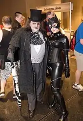 A photograph of cosplayers&nbsp;– a man dressed as the Penguin and a woman dressed as Catwoman