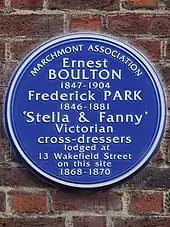 Circular blue plaque which reads: Ernest Boulton 1847–1904 Frederick Park 1846–1881 'Stella & Fanny' Victorian cross-dressers lodged at 13 Wakefield Street on this site 1868–1870