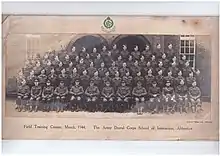 Formal picture of approx 50 males in Army Uniform, front row seated, with the Offiers,  then 4 rows standing probably on benches or staging, about 15 per row, presumably of dentists who were passing out following completion of the course