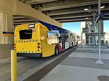 A METRO Orange Line bus boards passengers heading northbound on the freeway level of station