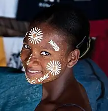 Image 10Malagasy girl in Nosy Be wearing masonjoany, an endemic decorative and protective paste made from ground wood (from Culture of Madagascar)