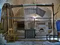 weaving a carpet in a caravansari in Meybod