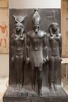 Statue of Menkaure with Hathor and Cynopolis; 2551–2523 BC; schist; height: 95.5 cm; Egyptian Museum (Cairo). Demonstrates a group statue with Old Kingdom features and proportions.