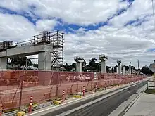 Concrete bridge pillars surrounded by scaffolding in a construction site