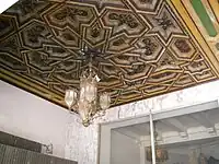 Ornate ceiling and lighting fixture at entrance