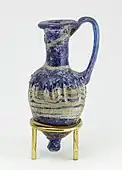 Perfume vase in shape of an amphoriskos; 664–630&nbsp;BC; glass: 8 × 4&nbsp;cm (3.1 × 1.5 &nbsp;in); Metropolitan Museum of Art