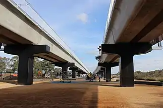 A playground underneath the train bridge