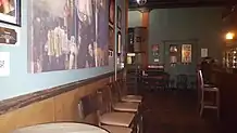 Photograph of the interior of a bar with various seats