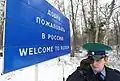 Bilingual welcome sign in Russian and English on Russian border, Russia.