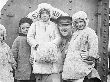 Refugee children that were separated from their parents during the Novorossiysk exodus with Lt. L.M. Foster, aboard the relief ship, Sangamon, March 1920