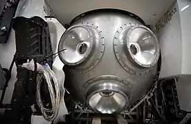 The titanium pressure hull during construction, with the acrylic viewports installed and the manipulator arm partly installed.