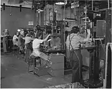 Women work in a west coast United States airplane factory on drill presses in 1942.